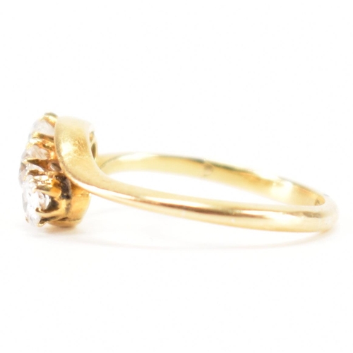 553 - A hallmarked 18ct gold and diamond three stone ring. The crossover ring being set with three graduat... 