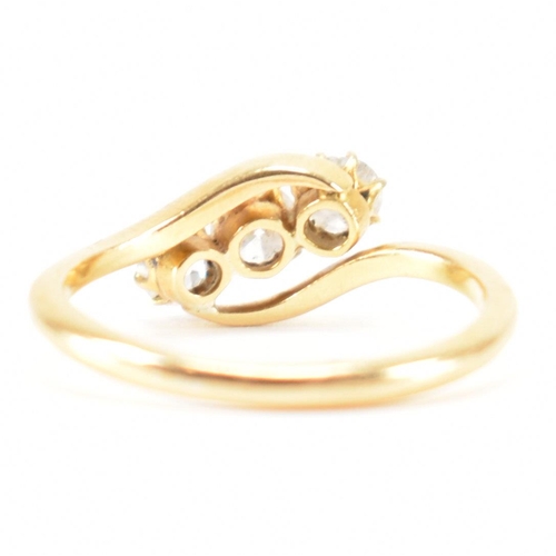 553 - A hallmarked 18ct gold and diamond three stone ring. The crossover ring being set with three graduat... 