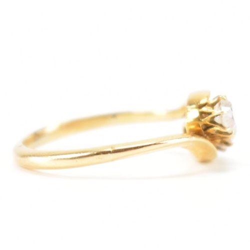 553 - A hallmarked 18ct gold and diamond three stone ring. The crossover ring being set with three graduat... 