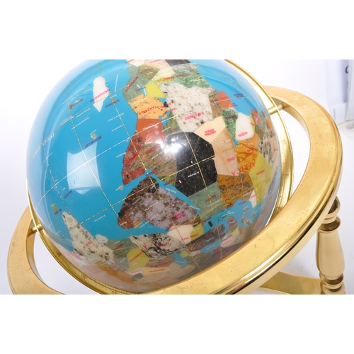 595a - A Lapis Lazuli encrusted table top / desk top revolving world globe. The gilt metal frame housing a ... 