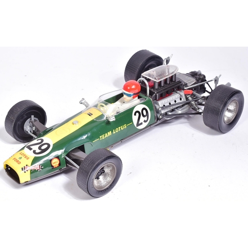 12 - Tinplate Toys - a vintage Japanese made tinplate battery operated model of a Lotus 49 Ford F-1 racin... 