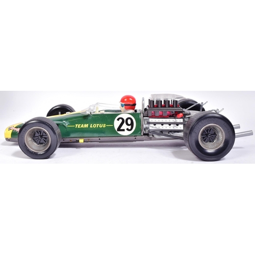 12 - Tinplate Toys - a vintage Japanese made tinplate battery operated model of a Lotus 49 Ford F-1 racin... 