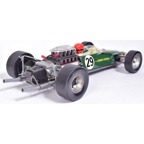 12 - Tinplate Toys - a vintage Japanese made tinplate battery operated model of a Lotus 49 Ford F-1 racin... 