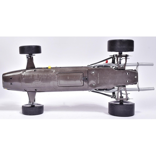 12 - Tinplate Toys - a vintage Japanese made tinplate battery operated model of a Lotus 49 Ford F-1 racin... 