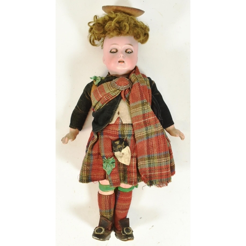 135 - An early 20th Century German Simon & Halbig bisque headed doll. Brown flirty eyes, finely painted br... 