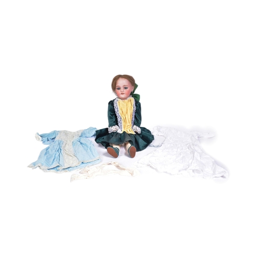 138 - An early 20th Century German Simon & Halbig bisque headed doll. The doll with blue flirty eyes, fine... 