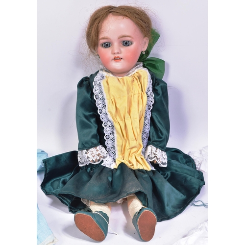 138 - An early 20th Century German Simon & Halbig bisque headed doll. The doll with blue flirty eyes, fine... 