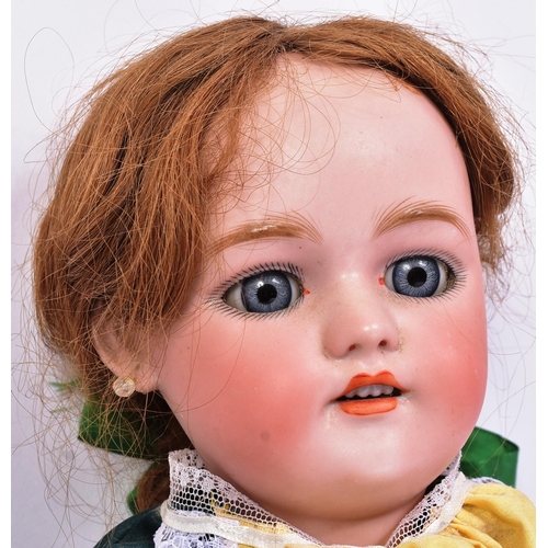 138 - An early 20th Century German Simon & Halbig bisque headed doll. The doll with blue flirty eyes, fine... 