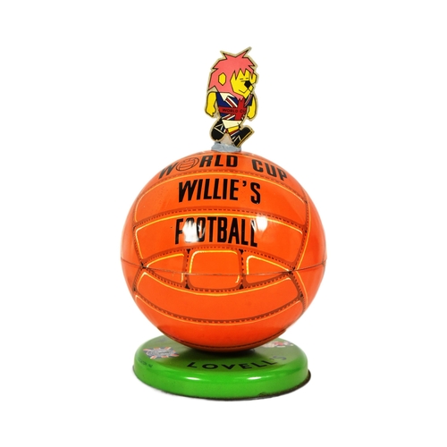 14 - An original vintage 1960s Lovells tinplate World Cup Willie toffee tin, designed as a football surmo... 