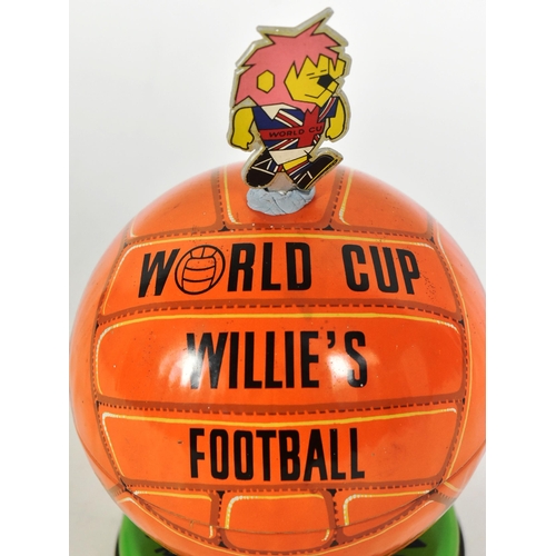 14 - An original vintage 1960s Lovells tinplate World Cup Willie toffee tin, designed as a football surmo... 