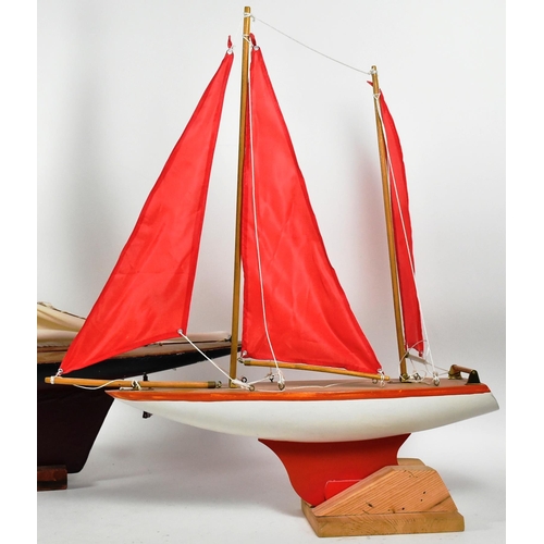 162 - Two vintage hand made scratch built wooden pond yachts. Varnished decks with rigged sails, one with ... 