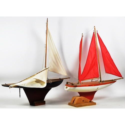 162 - Two vintage hand made scratch built wooden pond yachts. Varnished decks with rigged sails, one with ... 