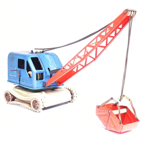 206 - Tinplate Toys - x2 vintage tinplate toys comprising a West German mechanical crane and a boxed Trian... 