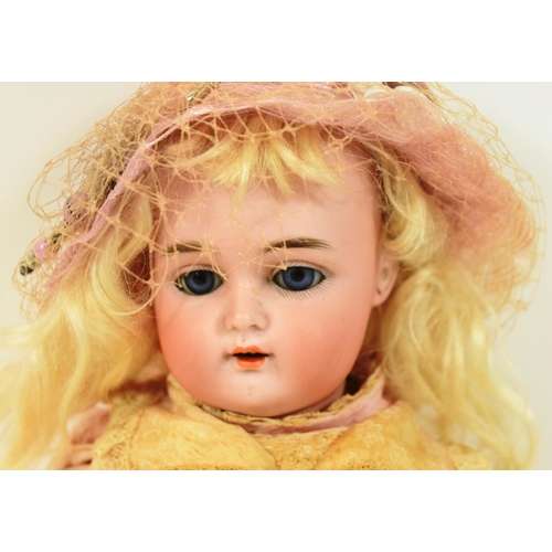 35 - An early 20th Century German Simon & Halbig bisque headed doll. Blue flirty eyes with finely painted... 