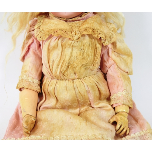 35 - An early 20th Century German Simon & Halbig bisque headed doll. Blue flirty eyes with finely painted... 