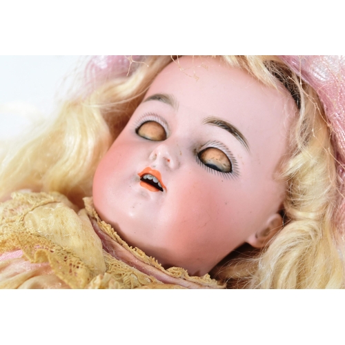 35 - An early 20th Century German Simon & Halbig bisque headed doll. Blue flirty eyes with finely painted... 