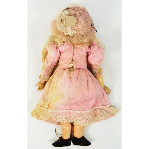 35 - An early 20th Century German Simon & Halbig bisque headed doll. Blue flirty eyes with finely painted... 