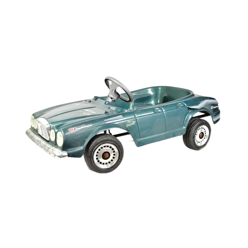 394 - An Italian made Jaguar V12 pedal car. Green plastic body with integrated seat, grey steering wheel a... 