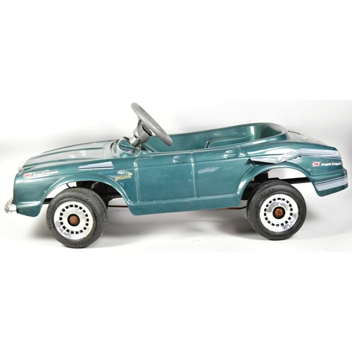 394 - An Italian made Jaguar V12 pedal car. Green plastic body with integrated seat, grey steering wheel a... 