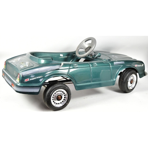 394 - An Italian made Jaguar V12 pedal car. Green plastic body with integrated seat, grey steering wheel a... 