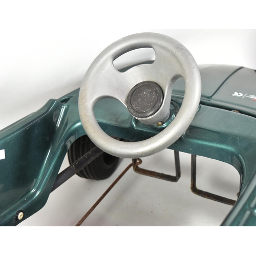 394 - An Italian made Jaguar V12 pedal car. Green plastic body with integrated seat, grey steering wheel a... 