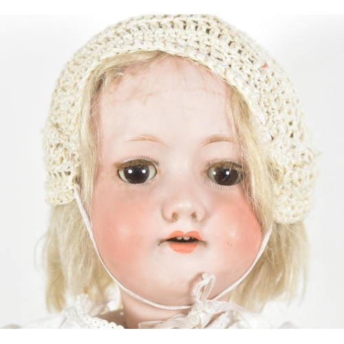 98 - An early 20th Century German Armand Marseille bisque headed doll. Brown flirty eyes, blonde lashes, ... 