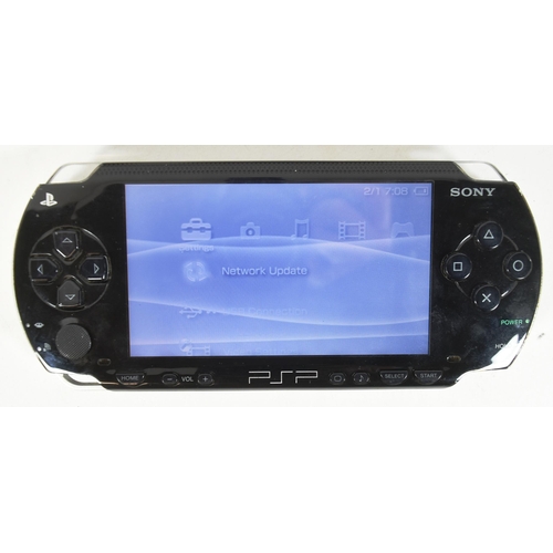 406 - Retro Gaming - an original Sony Playstation Portable PSP 1003 (black) and a Nintendo 3DS (pink)  han... 