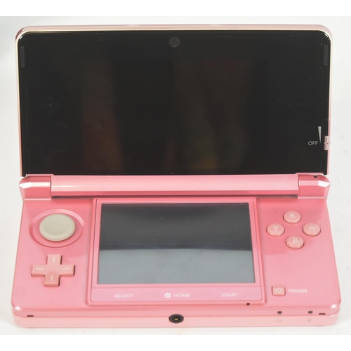 406 - Retro Gaming - an original Sony Playstation Portable PSP 1003 (black) and a Nintendo 3DS (pink)  han... 