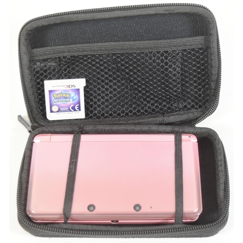 406 - Retro Gaming - an original Sony Playstation Portable PSP 1003 (black) and a Nintendo 3DS (pink)  han... 