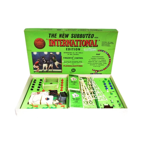 603 - An original vintage Subbuteo International Edition tabletop football game set. The set containing pi... 