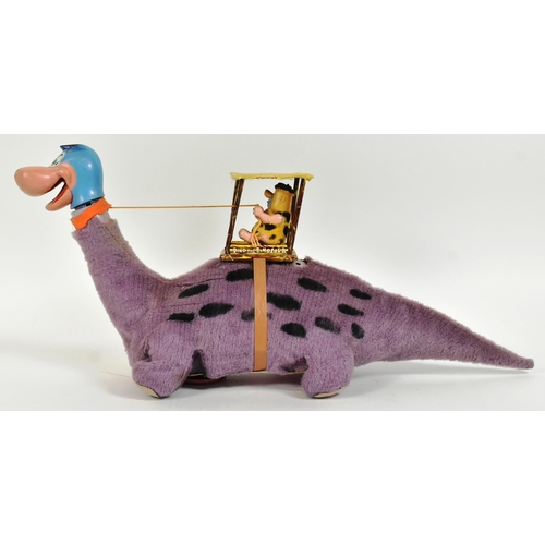 751 - The Flintstones - a vintage 1960s Louis Marx battery operated ' Fred on Dino ' mechanical toy. Tinpl... 