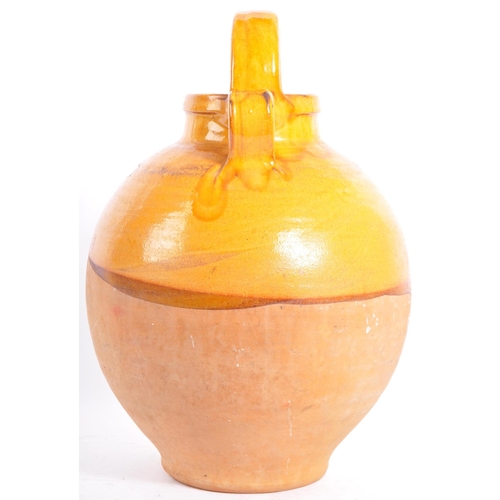 10 - A large proportion French earthenware gargoulette / water jug. The jug being of bulbous form, with a... 