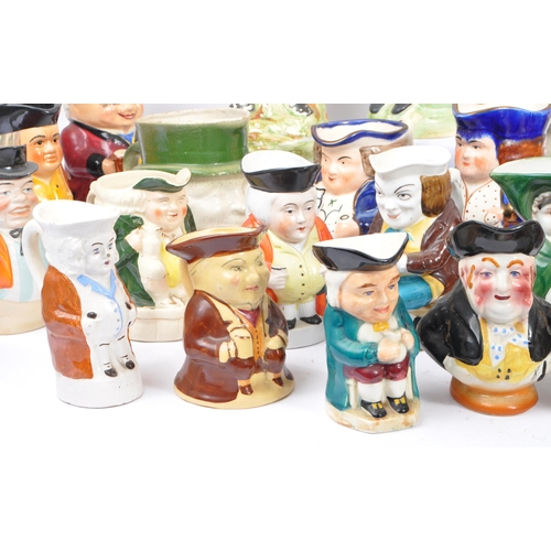 134 - A large collection of thirty 19th & 20th Century porcelain ceramic 'Toby & Character' jugs. A variet... 