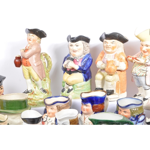 134 - A large collection of thirty 19th & 20th Century porcelain ceramic 'Toby & Character' jugs. A variet... 