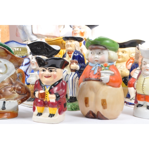 134 - A large collection of thirty 19th & 20th Century porcelain ceramic 'Toby & Character' jugs. A variet... 