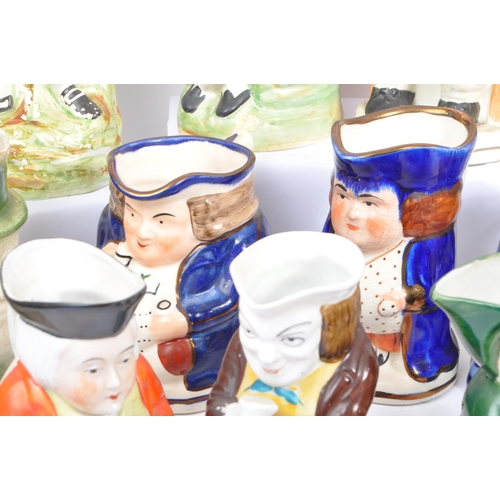 134 - A large collection of thirty 19th & 20th Century porcelain ceramic 'Toby & Character' jugs. A variet... 