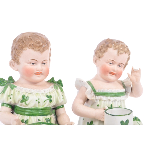 144 - Gebruder Heubach - A pair of matching late antique 19th century hand painted bisque piano child doll... 