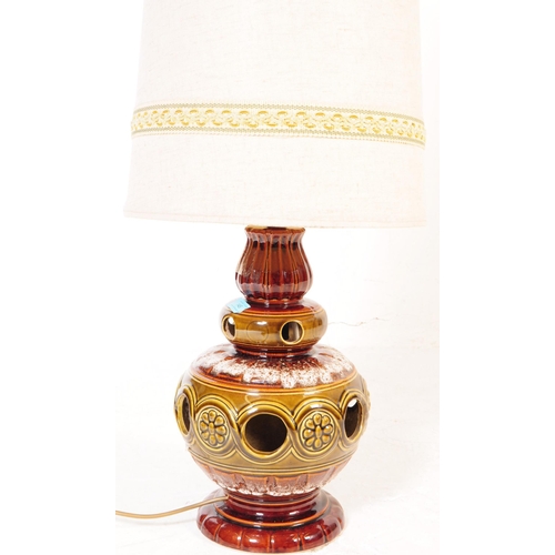 145 - A vintage mid 20th century West German studio pottery lamp base with cream colour conical fabric lam... 