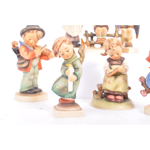 159 - Goebel - A collection of West German Goebel porcelain china figurines. Depicting young children, pla... 