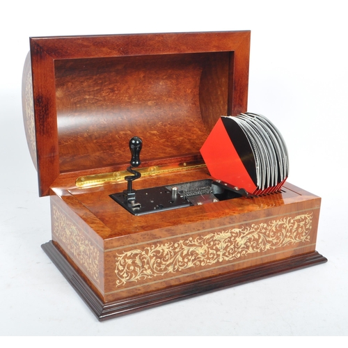 169 - A collection of three vintage 20th century wooden jewellery musical boxes. Including a polyphon with... 