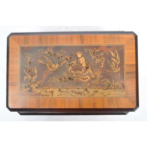 169 - A collection of three vintage 20th century wooden jewellery musical boxes. Including a polyphon with... 