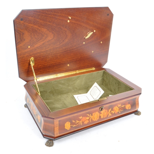 169 - A collection of three vintage 20th century wooden jewellery musical boxes. Including a polyphon with... 