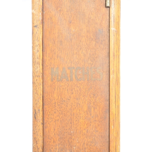 187 - An original early 20th century oak wood wall mounted match dispenser. With internal aluminium casing... 