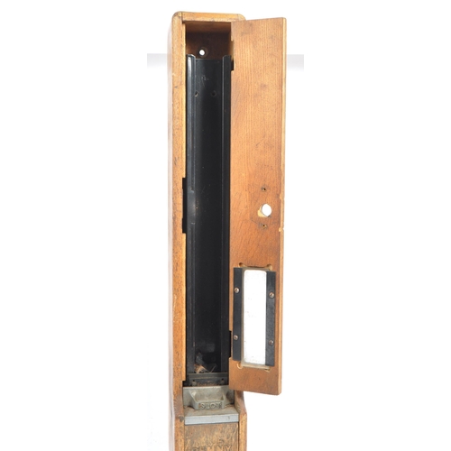 187 - An original early 20th century oak wood wall mounted match dispenser. With internal aluminium casing... 