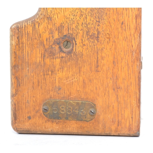 187 - An original early 20th century oak wood wall mounted match dispenser. With internal aluminium casing... 