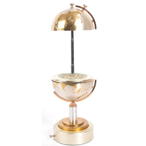 201 - A mid 20th century circa 1960s metal cigarette dispenser in the form of a world globe. The dispenser... 