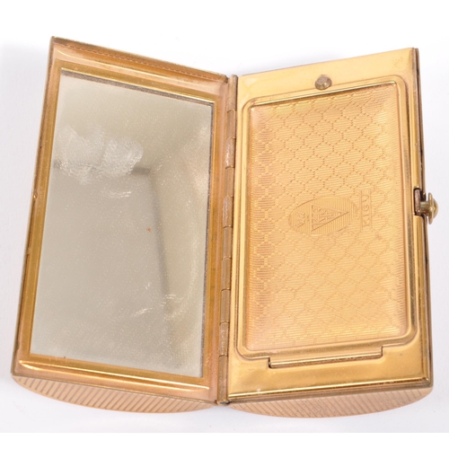 206 - Kigu - A vintage 20th century circa 1950s gilt metal ladies pocket compact. The case having engine t... 