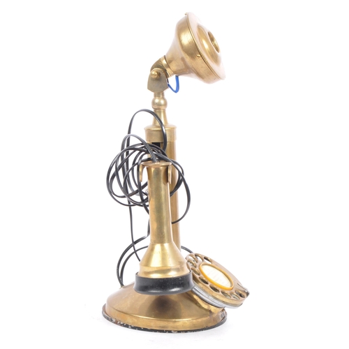 208 - An early 20th century circa 1920s brass candlestick telephone. The telephone being of brass construc... 