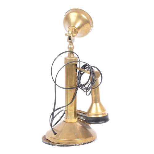 208 - An early 20th century circa 1920s brass candlestick telephone. The telephone being of brass construc... 