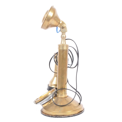 208 - An early 20th century circa 1920s brass candlestick telephone. The telephone being of brass construc... 